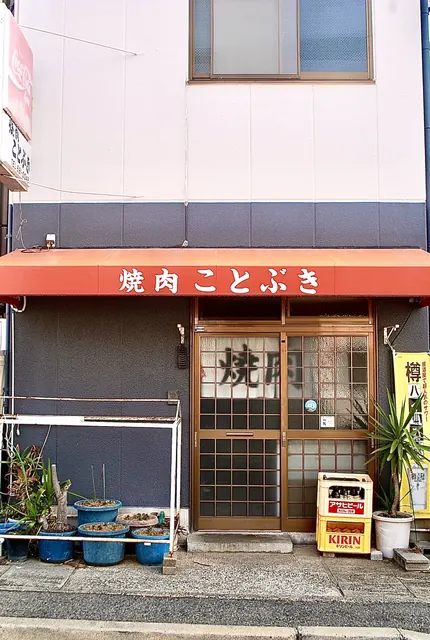 「焼肉 ことぶき」の日よけと、格子戸の入口