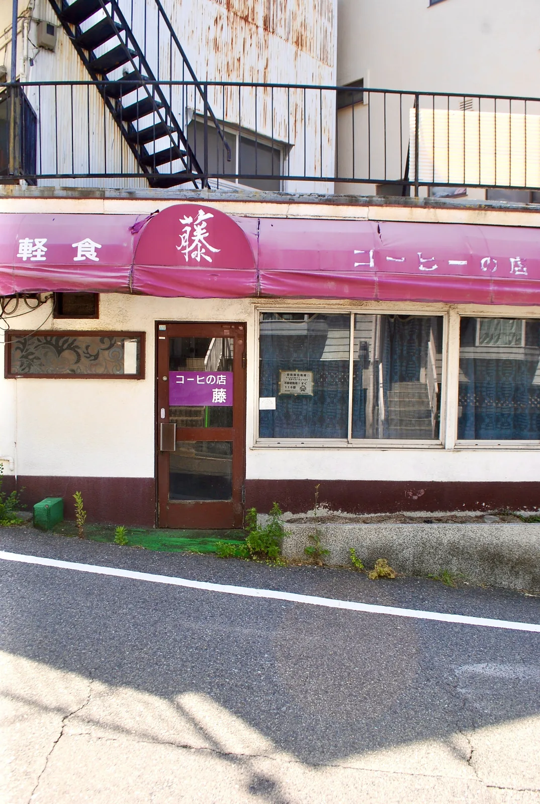赤い日よけと「コーヒの店」の看板のある、昔ながらの喫茶店